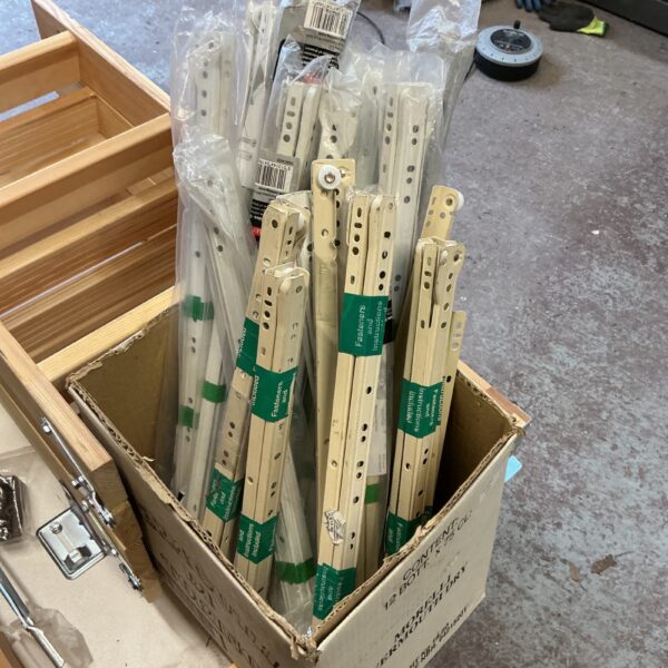Metal drawer runners in a box, ideal for furniture repair.