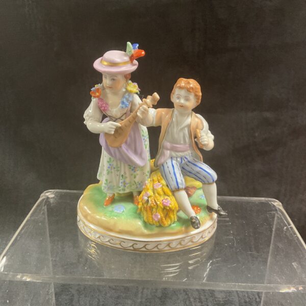 Antique Dresden porcelain figurine of a couple, detailed and colourful.
