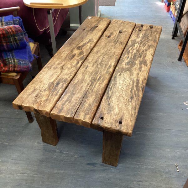 Rustic driftwood coffee table with natural wood grain.