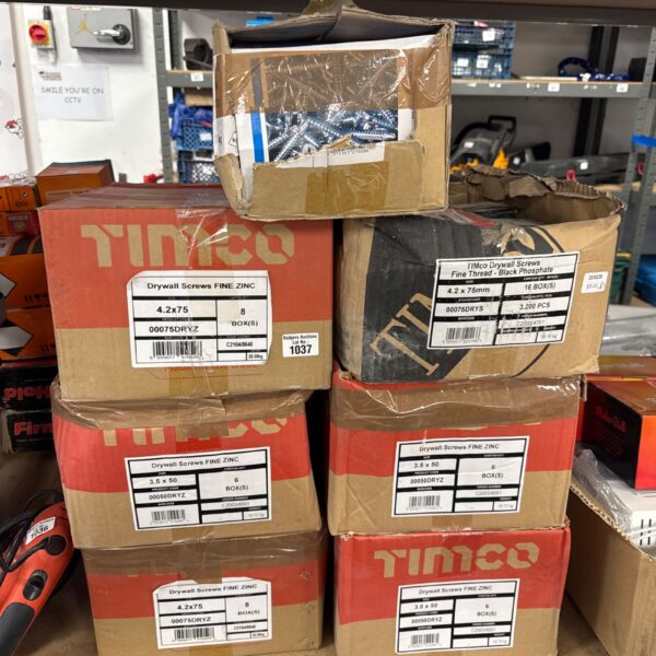 Stack of sealed boxes of Timco drywall screws for construction.