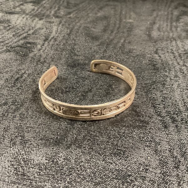 Close-up of vintage Egyptian silver bracelet with intricate detailing.