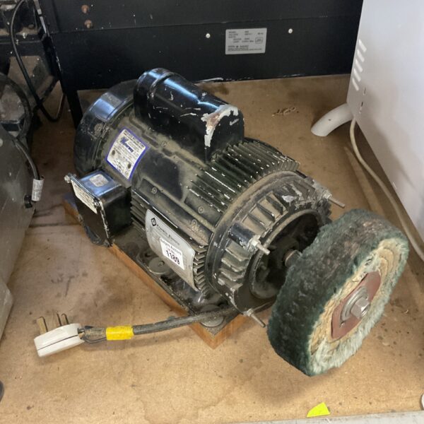 Industrial electric induction motor assembly with pulley wheel.