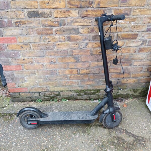 Black electric scooter with charger, ideal for urban commuting.