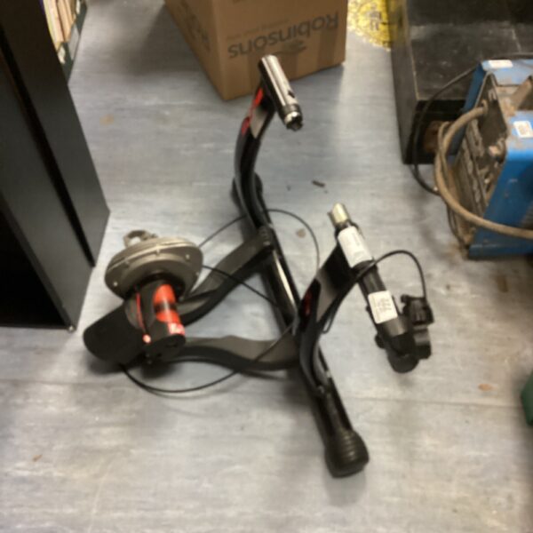 Side view of a used Elite bike trainer for indoor cycling.