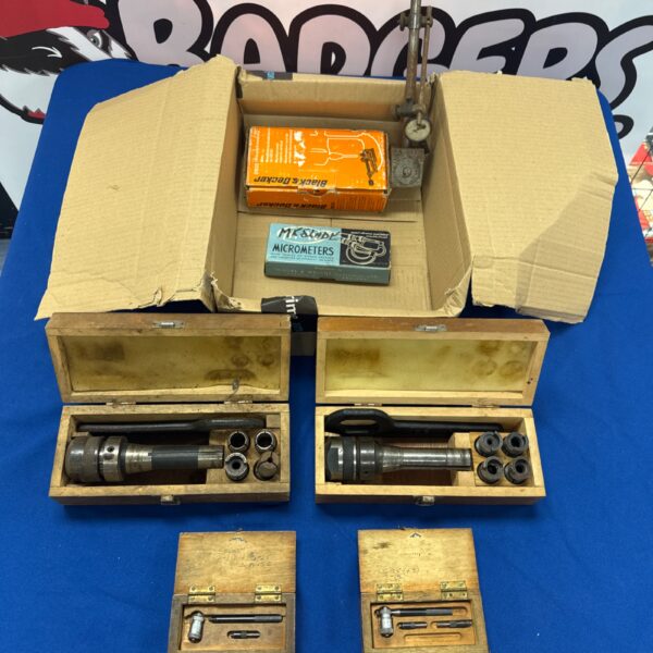 Vintage engineering measurement tools including a micrometer in wooden case.