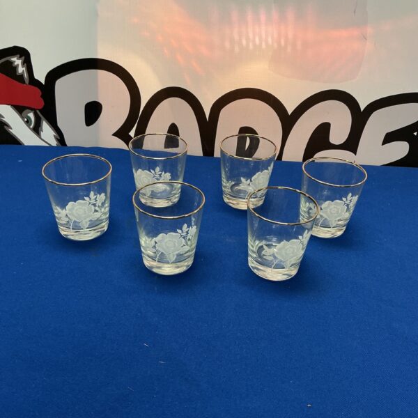 Set of six vintage etched glass tumblers with gold rims.