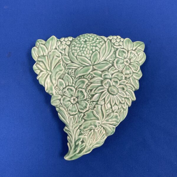 Vintage Falcon Ware green ceramic floral wall pocket displayed on blue background.