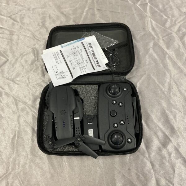 Compact folding portable drone with remote control for aerial photography.