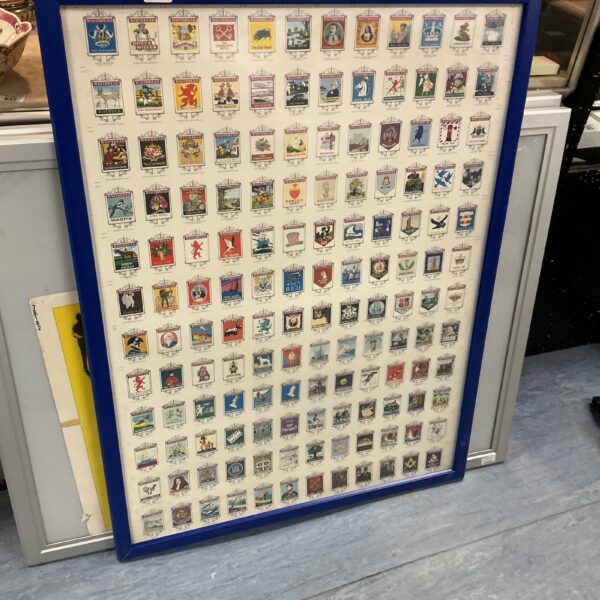 Framed collection of vintage Whitbread pub signs for collectors.