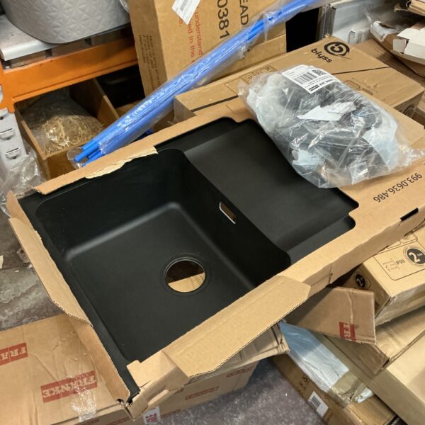 Black Frankie Tectonite sink with fittings for kitchen installation.