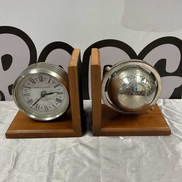 Vintage French Gallery globe and clock bookends on a dark surface.