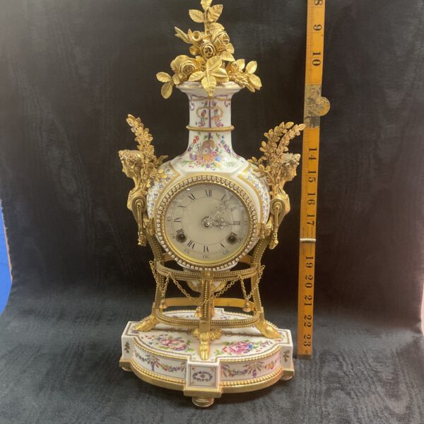 Ornate French porcelain mantle clock with floral details.
