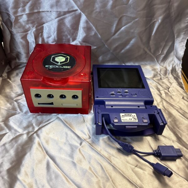 Red GameCube console with purple mobile monitor attached.
