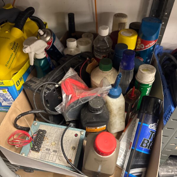 Mixed garage clearance lot with tools and fluids.