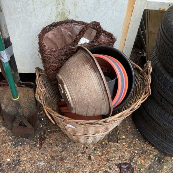 Mixed lot of garden planters and baskets for outdoor gardening.