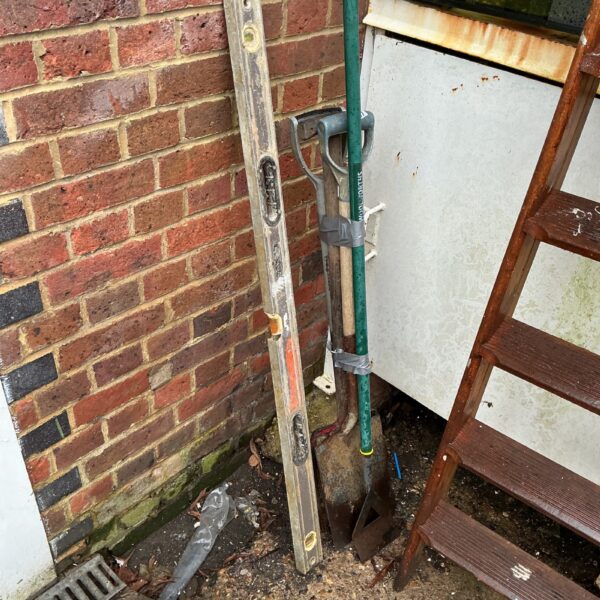 Vintage garden tools and spirit level for DIY projects.