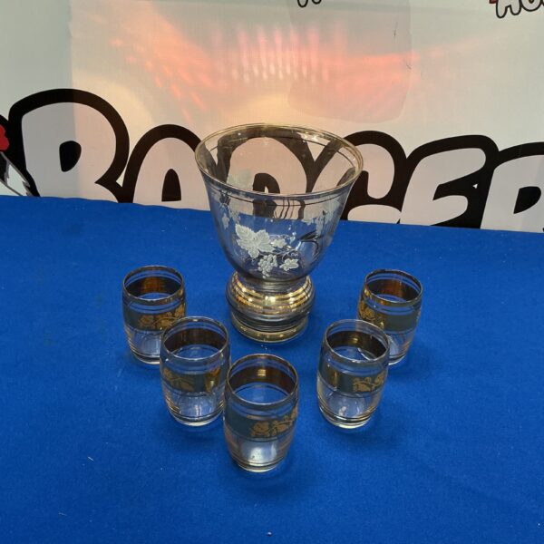 Vintage gold rimmed glassware set with vase and glasses.