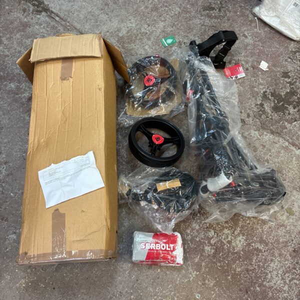 Golf cart parts laid out on pavement, showing components.