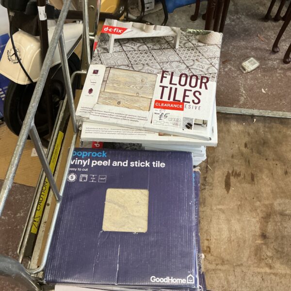 Stack of Goodhome vinyl floor tile packs for DIY flooring.