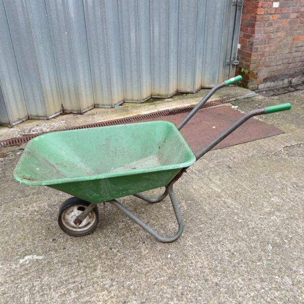 Green plastic wheelbarrow for garden and yard work.