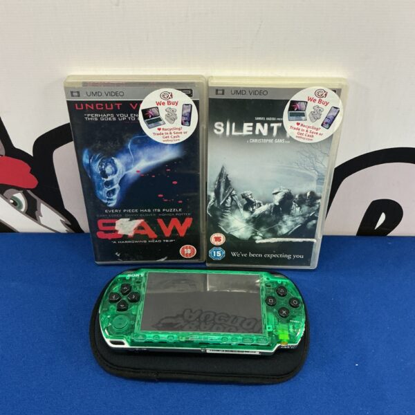 Green Sony PSP console with UMD movies, retro handheld gaming.