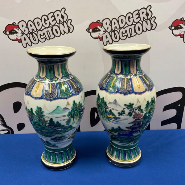 Pair of vibrant hand-painted oriental vases on display.