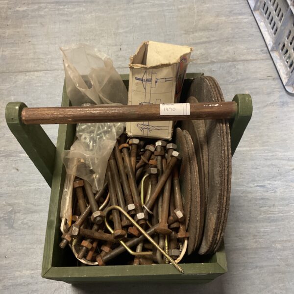 Wooden caddy filled with a diverse hardware assortment.