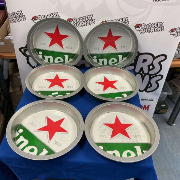 Lot of seven vintage Heineken drink trays with red star logo.