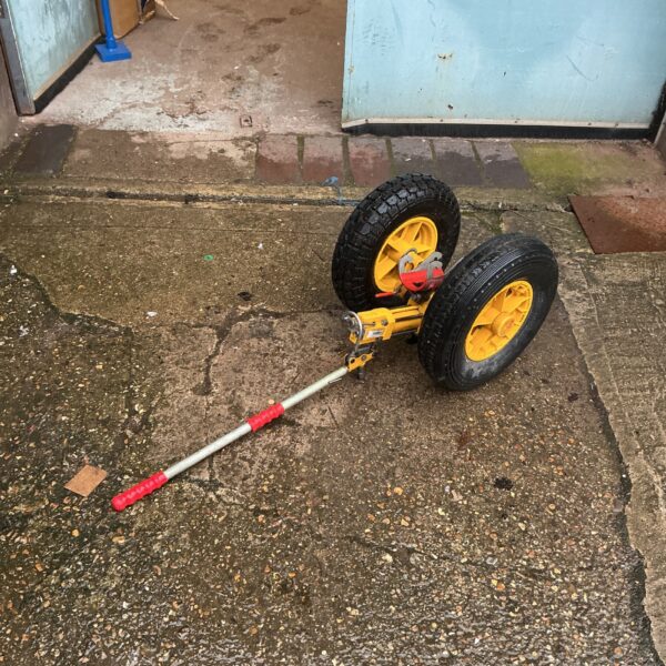 Heavy-duty helicopter towing cart with pivoting wheels.