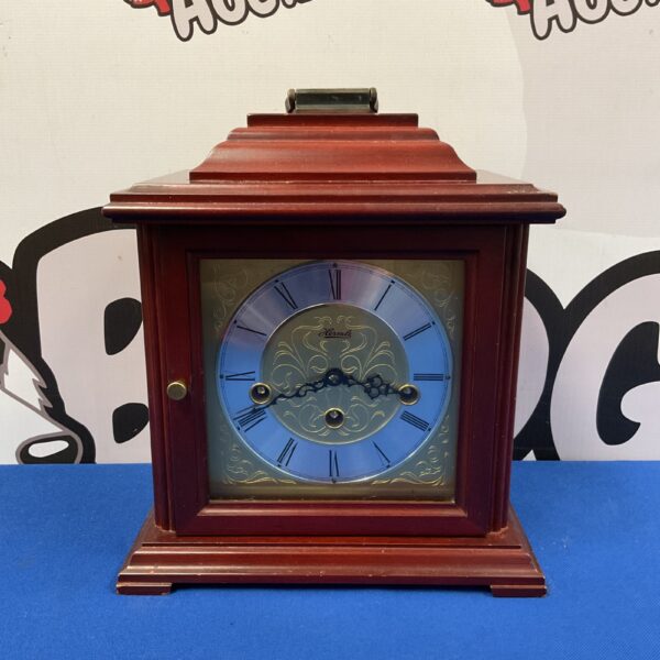 Front view of a vintage Hermle German mantle clock.
