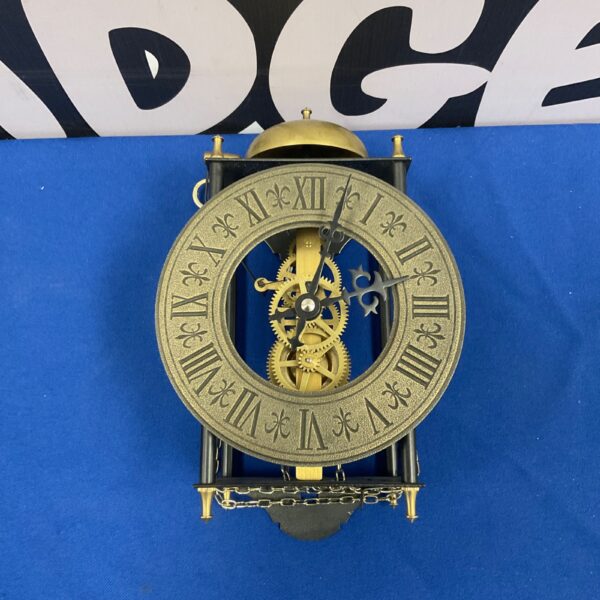 Antique Hermle Stanford skeleton wall clock with visible brass gears.
