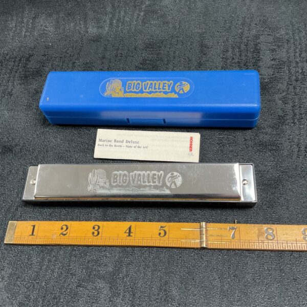 Vintage Hohner Big Valley harmonica with its original blue case.