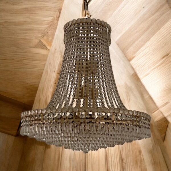 Vintage Hollywood Regency brass and crystal chandelier, glamorous lighting.