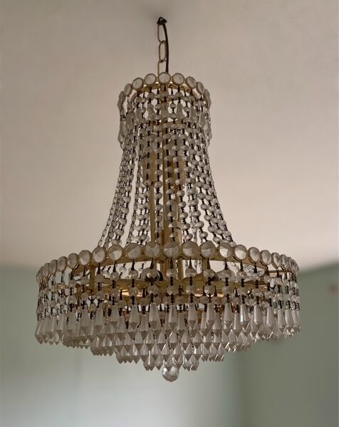 Vintage Hollywood Regency crystal chandelier with brass frame.