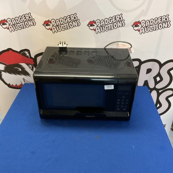 White HotPoint microwave oven on a countertop.