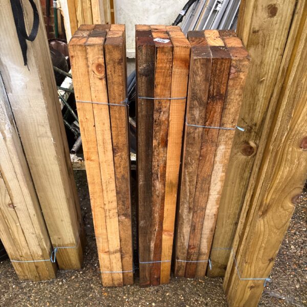 Three bundles of approximately 3.5 ft timber