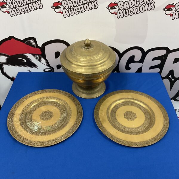 Vintage Indian brass dishes and lidded container set on display.
