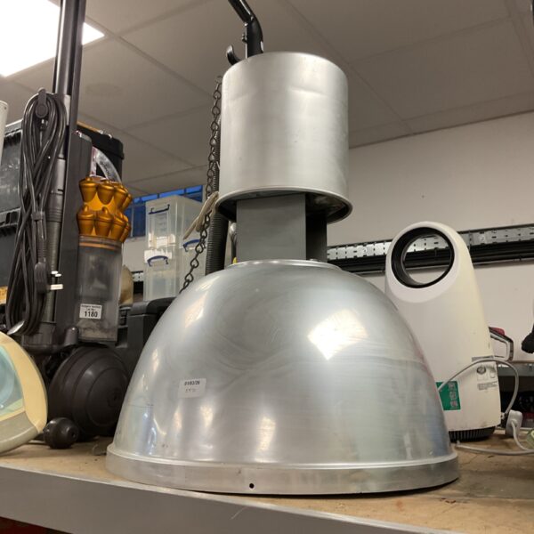 Vintage industrial heat lamp with metal reflector and chain.