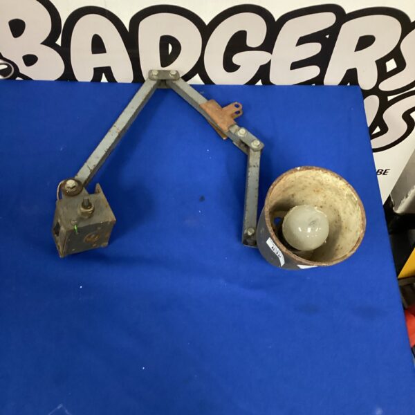 Vintage industrial spot lamp with adjustable arm.