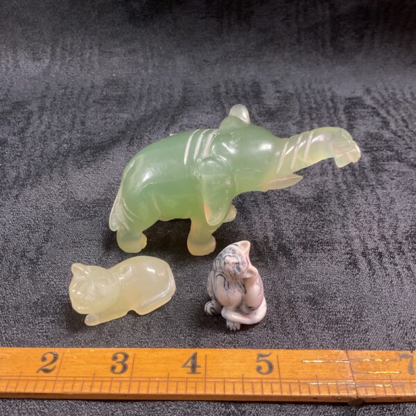 Pale green jade elephant sculpture, detailed carving, Asian art.
