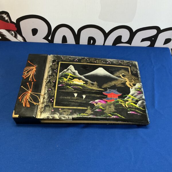 Vintage Japanese lacquered photo album with detailed artwork on the cover.