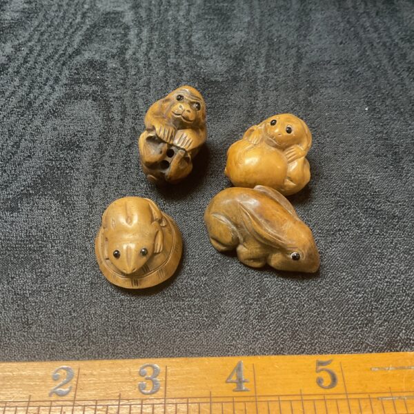 Antique Japanese netsuke lot featuring miniature carved figures.