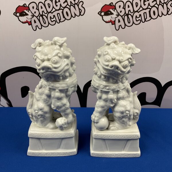 Pair of antique Japanese porcelain Foo Dog statues for collectors.