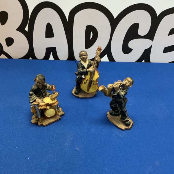 Group of vintage jazz musician figurines, drummer, saxophonist, bassist.