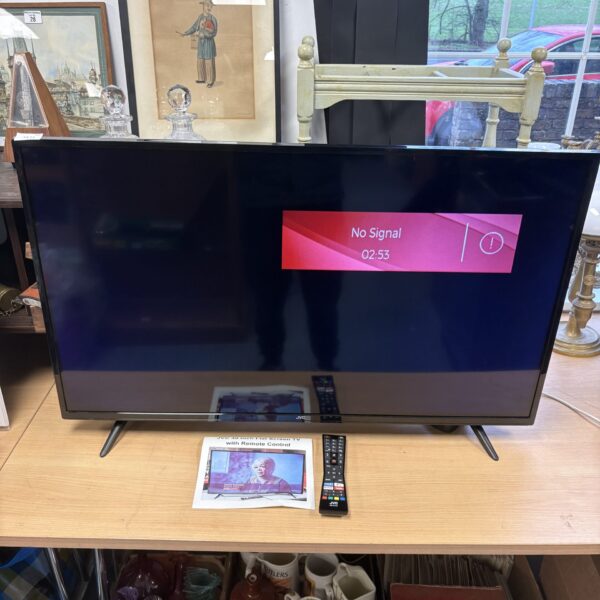 JVC 14 inch flatscreen television with remote control.