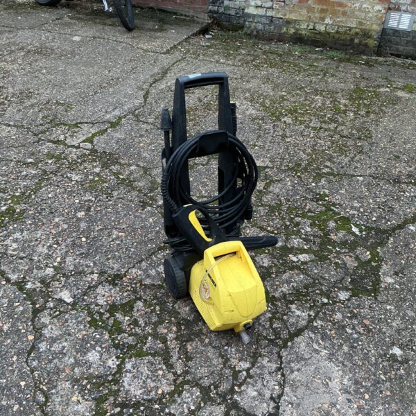 Yellow Karcher pressure washer with wheels for outdoor cleaning.