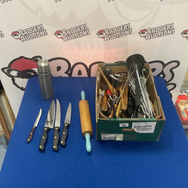 Mixed kitchenware lot with knives, spoons, and a flask.