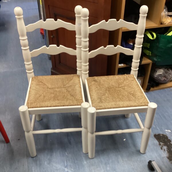 Pair of vintage ladder back dining chairs with rush seats.
