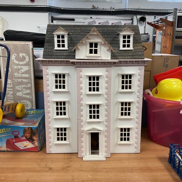 Front view of a large Victorian dolls house with multiple windows.
