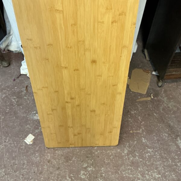 Large wooden chopping board for kitchen food preparation.